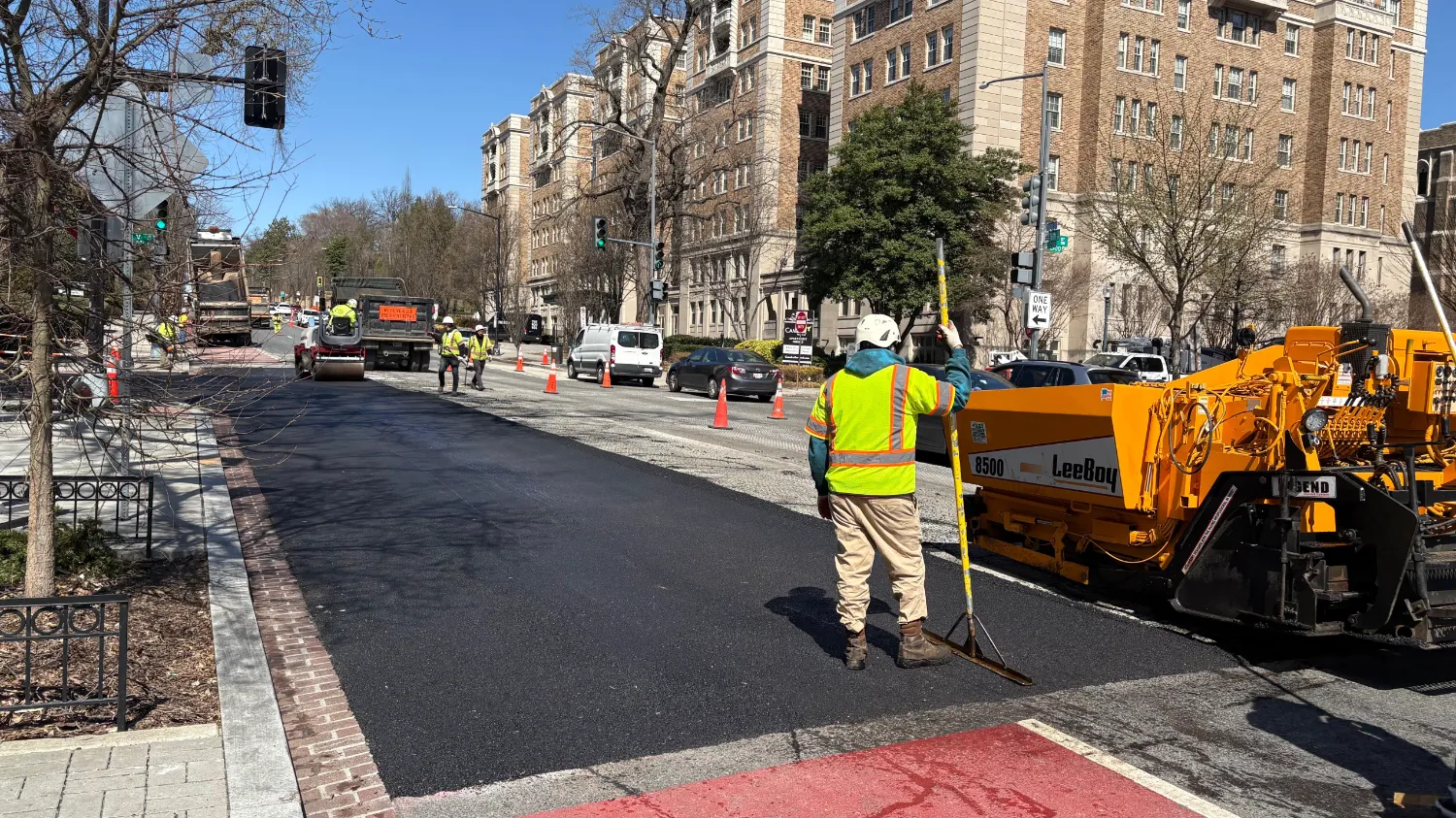 21ea1f19-1c81-40e1-8172-0dfa8a803ccf A road crew is using heavy machinery to repave a city street.